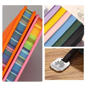 Custom A5 notebook with colorful spray-painted edges and metal charm bookmark detail