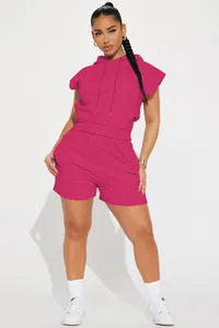 Full view of model wearing a vibrant deep pink sleeveless hoodie and shorts casual suit.