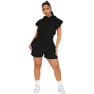 Detailed view of a black sleeveless hooded top and matching shorts worn by a female model.