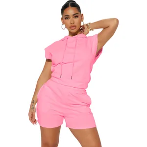 Full body detail of a vibrant pink two-piece set with sleeveless hoodie and shorts