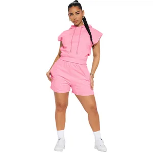 Full-length studio shot of a pink sleeveless hoodie and shorts casual set on a model.