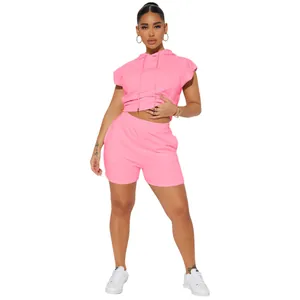 High-quality detail shot of a women's pink sleeveless crop hoodie and shorts set
