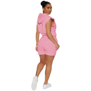 Rear view of a woman wearing a pink sleeveless hooded top and matching lounge shorts.