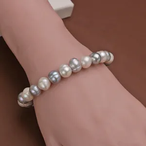 Close-up of elegant 8-9mm grey and white freshwater pearl bracelet on wrist