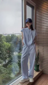 Stylish light blue two-piece tracksuit set for women featuring short-sleeve hoodie and pants