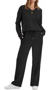 Full view of black loungewear set featuring V-neck top and drawstring waist pants on model