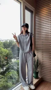Casual grey sleeveless hoodie and wide-leg pants set for women in a lifestyle setting.