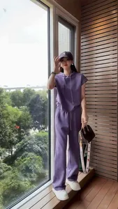 Fashionable purple two-piece sports set with sleeveless hoodie and wide-leg pants.