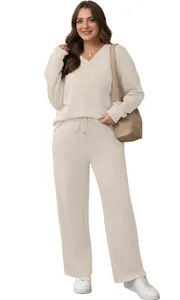 Comfortable beige two-piece loungewear set with V-neck top and drawstring trousers.