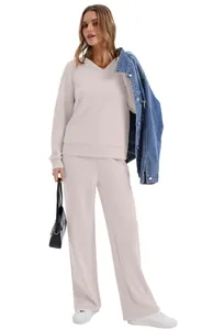 Two-piece minimalist beige lounge set featuring V-neck top and matching wide-leg pants