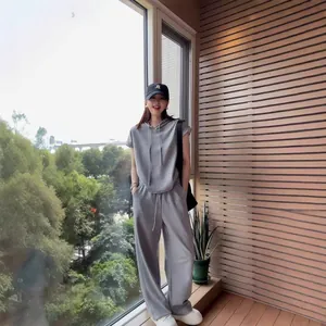 Women's casual grey two-piece tracksuit set with short sleeve hoodie and wide leg pants.