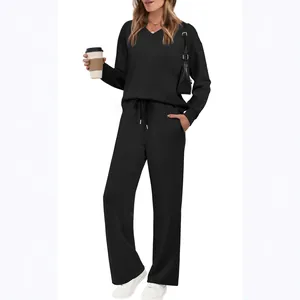 Women's black 2-piece lounge set with V-neck top and wide-leg drawstring pants.