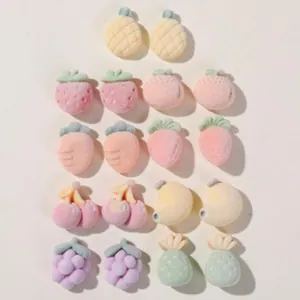 Close-up of various pastel fruit-shaped flocked charms for DIY hair accessories