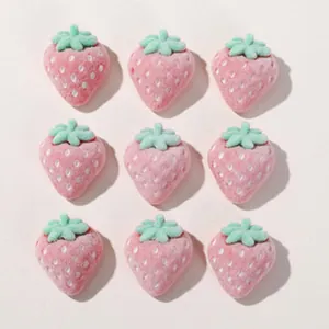 Close-up of pink strawberry resin flatbacks for DIY hair accessories