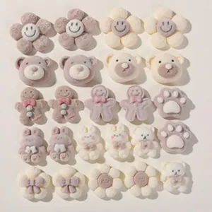 Collection of cute plush DIY charms including bears, flowers, and paws
