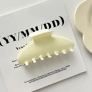 Large cream-colored shell acrylic hair claw clip for elegant minimalist styling