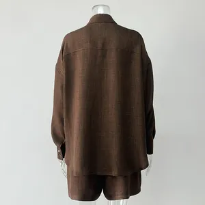 Back view of minimalist brown linen-textured long-sleeve shirt and shorts set on mannequin