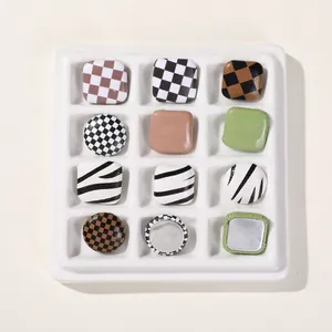 Close-up of checkered and zebra pattern DIY charms for hair accessories