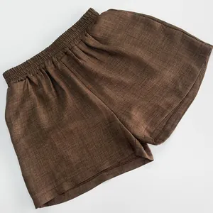 Detailed view of high-waisted brown linen-blend shorts featuring an elastic waistband