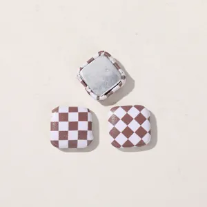 Detailed view of square brown checkerboard DIY buttons for craft accessories