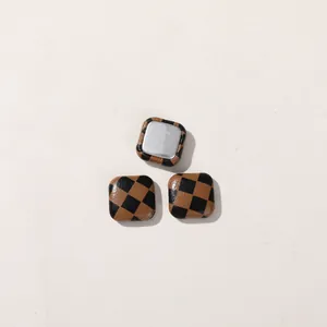 Detailed view of brown and black checkerboard square buttons for various DIY craft projects.