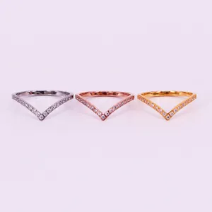 Set of three V-shaped stainless steel rings with CZ pavé in silver, gold, and rose gold