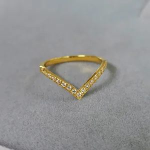 Elegant gold titanium steel V-shaped chevron ring featuring sparkling pavé crystals