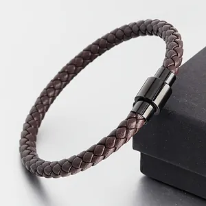 Detailed view of brown braided leather bracelet with black magnetic clasp