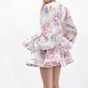 Back view of a white floral mini dress with lantern sleeves and tiered ruffles