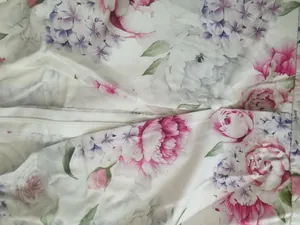 Close-up detail of the elegant floral print fabric and white zipper on a women's dress