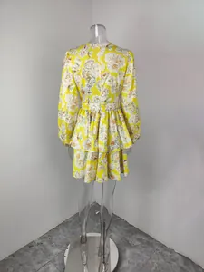 Rear view of a stylish yellow floral print tiered dress featuring elegant lantern sleeves