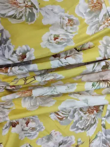 Detailed macro shot of elegant yellow floral print fabric for a stylish spring dress