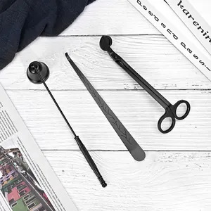 Elegant black stainless steel candle accessory set including wick trimmer, snuffer, and dipper.