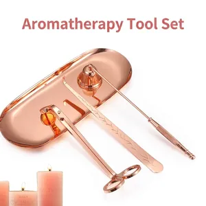 Elegant rose gold stainless steel candle accessory set with wick trimmer and snuffer.
