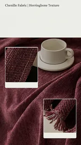 Detail view of burgundy chenille sofa throw with herringbone texture and tassels