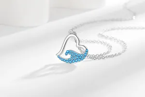 Macro view showing the intricate blue stone wave inlay on heart-shaped pendant.