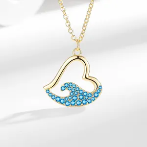 Elegant gold heart necklace with blue wave rhinestones, minimalist ocean jewelry for women.