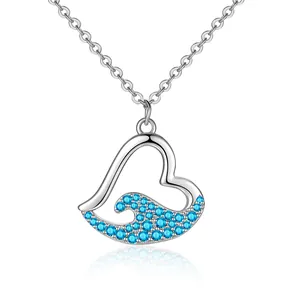 Elegant silver heart necklace featuring a blue rhinestone wave design on a white backdrop