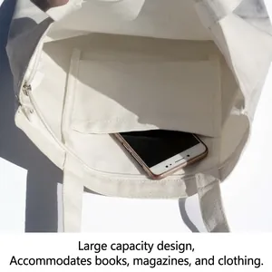 Minimalist white canvas tote bag with functional interior pocket detail