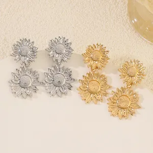 Detailed view of silver and gold sunflower dangle earrings with intricate petal textures