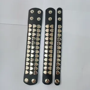 Detailed display of black punk faux leather bracelets with silver heart-shaped metal studs