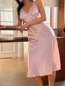 Detailed view of elegant pink satin nightdress with delicate lace trim V-neckline detail