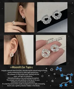 Detailed shot of silver lava texture stud earrings featuring white agate donut stones