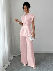 Elegant pink two-piece set featuring short sleeve tie-front shirt and straight trousers.