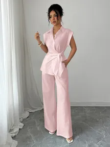 Elegant pink short-sleeve wrap shirt and wide leg trousers two-piece set for women.