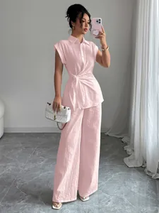 Elegant pink two-piece set featuring a short-sleeved shirt and wide-leg trousers