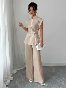 Elegant beige two-piece set featuring sleeveless tie-waist shirt and wide-leg trousers