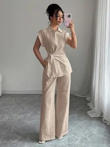 Full view of elegant beige short-sleeve shirt and wide-leg trousers set
