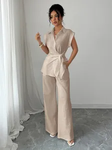 Elegant two-piece beige set featuring a tie-waist shirt and wide-leg trousers for women.