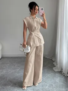 Full-length detail of elegant beige short-sleeved shirt and wide-leg pants set